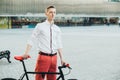 Hipster with red bycicle and tattoo on leg Royalty Free Stock Photo