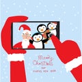 Hipster santa claus selfie with penguins by smartphone for merr