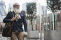 Hipster senior business man walking with takeaway coffee outdoors in winter day - Focus on face Royalty Free Stock Photo