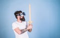 Hipster on serious face enjoy play game in virtual reality. Gamer concept. Man with beard in VR glasses, light blue Royalty Free Stock Photo