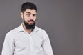 Hipster with serious face. Feeling and emotions. Guy or bearded man on grey background. Barber fashion and beauty. Man Royalty Free Stock Photo