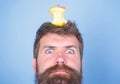 Hipster shocked face with apple stump target on head blue background, close up. Weight loss goal. Live target concept