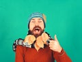 Hipster with shocked smiling face and beard full of leaves