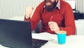 Hipster shows Yes gesture. Business man celebrating business success. Happy bearded man working on laptop Royalty Free Stock Photo