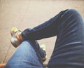 A hipster sitting downtown with crossed legs on a sidewalk bench Royalty Free Stock Photo