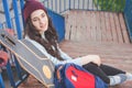 Hipster skateboarder girl with skateboard standing outdoor