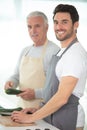 hipster son with senior father cooking