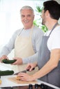 hipster son with senior father cooking in kitchen Royalty Free Stock Photo