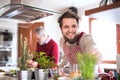 Hipster son with his senior father cooking in the kitchen. Royalty Free Stock Photo