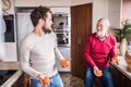 Hipster son with his senior father in the kitchen. Royalty Free Stock Photo