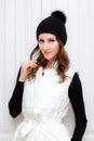 Hipster Style Brunette Girl Swag wearing Black fashion beanie knitted hat with bumbon pumpon. Season Fall Winter Royalty Free Stock Photo