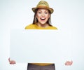 Hipster style girl holding big white sign board. Royalty Free Stock Photo