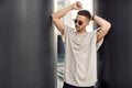 Hipster style guy. Fashion man standing near black wall Royalty Free Stock Photo