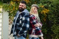 Hipster style. Lumberjack style. Couple wear checkered clothes nature background. Man bearded hipster and girl wear kepi