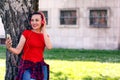 hipster stylish beautiful girl listening to music, mobile phone, headphones, enjoying, smiling, happy, having fun, laughing, park. Royalty Free Stock Photo