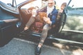 Hipster stylish man using tablet sitting inside convertible electric car - Senior entrepreneur having fun with technology trends