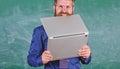 Hipster teacher wear eyeglasses and necktie bites laptop. Man hungry for knowledge. He needs new information. Thirst of Royalty Free Stock Photo