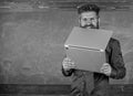 Hipster teacher wear eyeglasses and necktie bites laptop. Man hungry for knowledge. Teacher bearded man bites modern Royalty Free Stock Photo