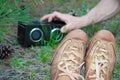 Hipster teenager relax on the ground and listening music in green sammer park