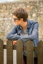 Hipster teenager with sunglasses over a fence Royalty Free Stock Photo