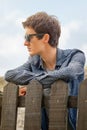 Hipster teenager with sunglasses over a fence Royalty Free Stock Photo