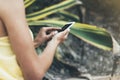 Hipster text message on smart phone or technology, mock up of blank screen. Young girl using cellphone on yellow flower background Royalty Free Stock Photo