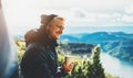 Hipster tourist hold in hands mug of hot drink, lonely guy smile enjoy sun flare mountain in auto, happy traveler drink cup of tea Royalty Free Stock Photo