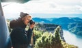 Hipster tourist hold in hands taking photography click on retro vintage photo camera in auto, photographer looking on camera techn