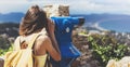 Hipster tourist look observant binoculars telescope on panoramic view, lifestyle concept trip, traveler with backpack on back Royalty Free Stock Photo