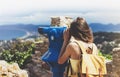 Hipster tourist look observant binoculars telescope on panoramic view, lifestyle concept trip, traveler with backpack on backgroun Royalty Free Stock Photo