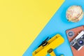 Hipster travel blogger accessories flatlay on blue yellow and pink
