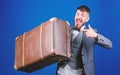 Hipster traveler with baggage. Baggage insurance. Man well groomed bearded hipster with big suitcase. Take all your Royalty Free Stock Photo