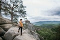 Hipster treveler standing alone on the edge cliff mountain and looking away. Adventure vacation Royalty Free Stock Photo