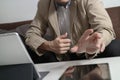 hipster using digital tablet computer on table and sitting on so