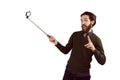 Hipster using his seflie stick Royalty Free Stock Photo