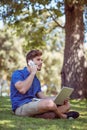 Hipster using laptop in the park