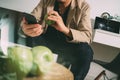 hipster using smart phone and digital tablet computer and holding credit card payments online business,sitting on sofa in living