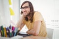 Hipster wearing eye glasses working at computer desk Royalty Free Stock Photo