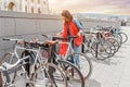 Woman parking her bicycle on the street in old town