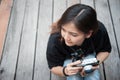 Hipster woman taking photos with retro film camera on wooden floorof city park,beautiful girl photographed in the old camera Royalty Free Stock Photo