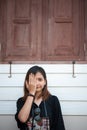 Hipster woman taking photos with retro film camera on wooden floorof city park,beautiful girl photographed in the old camera Royalty Free Stock Photo