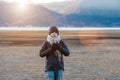 Hipster woman traveler with sweater and backpack traveling at Napa Lake, Happy young Hiker looking mountain and sunset in trip Royalty Free Stock Photo