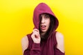 Hipster woman wearing a hood and winking to the camera Royalty Free Stock Photo