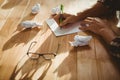 Hipster writing on paper at desk in office Royalty Free Stock Photo