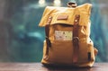 Hipster yellow backpack and map closeup. View from front tourist traveler bag on background blue sea aquarium. Person hiker visiti Royalty Free Stock Photo