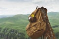 Hipster yellow vintage backpack with a mug fixed on it with a mug close-up front view. Traveler`s travel bag in the Royalty Free Stock Photo