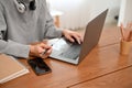 A hipster young Asian male freelancer working on his project on laptop at home. cropped shot Royalty Free Stock Photo