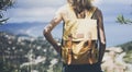 Hipster young girl with bright backpack looking at a map and poining hand the travel plan. View from the back of the tourist Royalty Free Stock Photo