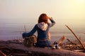 Hipster young tourist girl in jeans, sneakers with a bag sitting Royalty Free Stock Photo