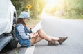 Hipster young woman looking for way during her road-trip. Royalty Free Stock Photo